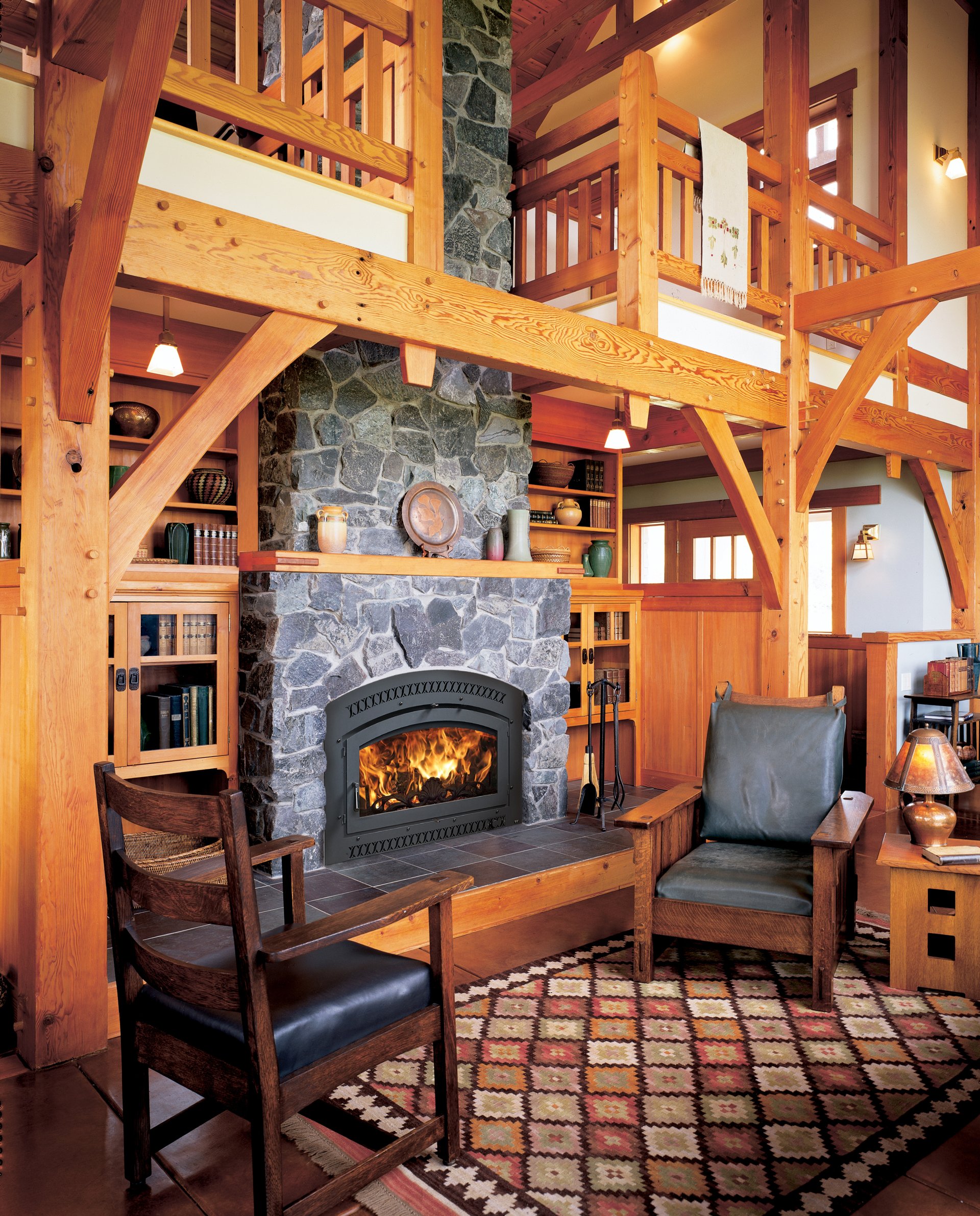 Fireplace Xtrordinair in timber-frame cabin with stone surround