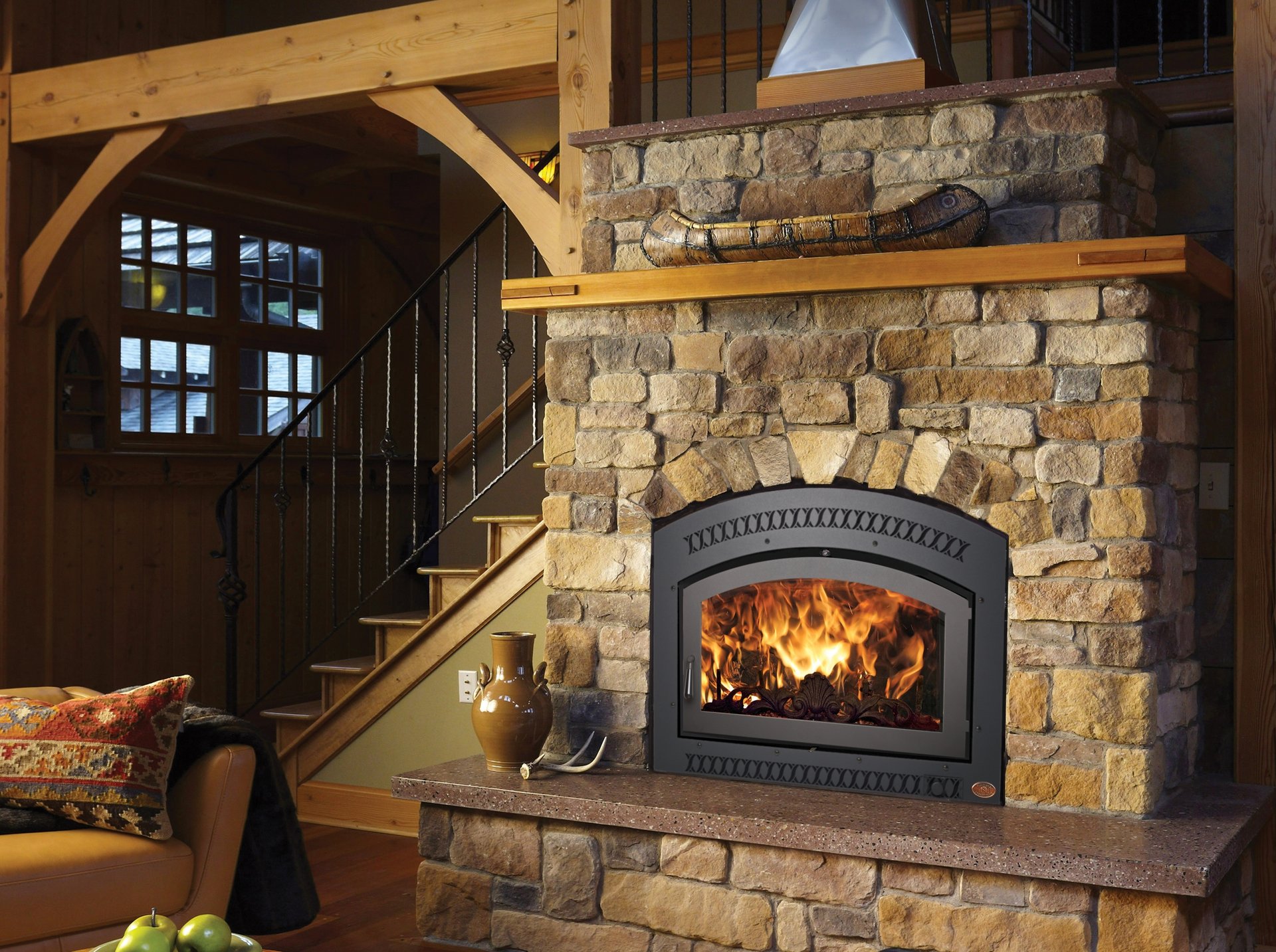 FPX arched stone wood-burning fireplace with iron door